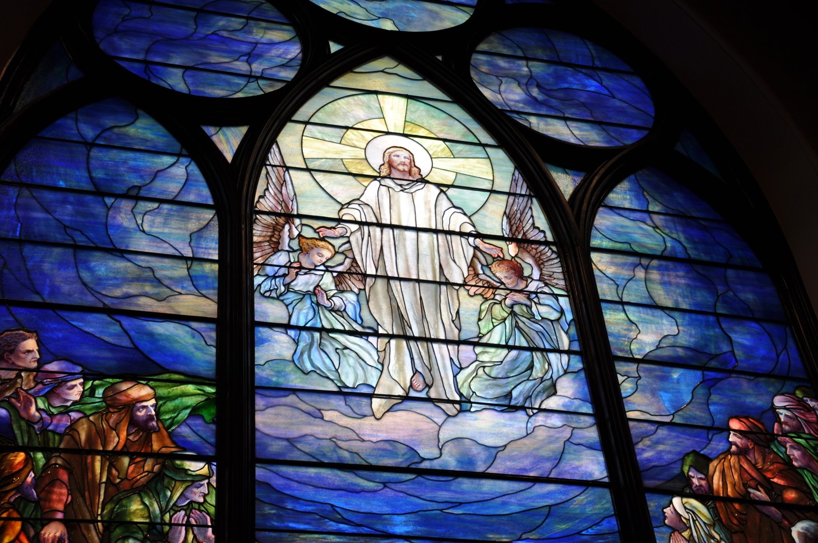 Professional inspection of stained glass windows in a restoration studio