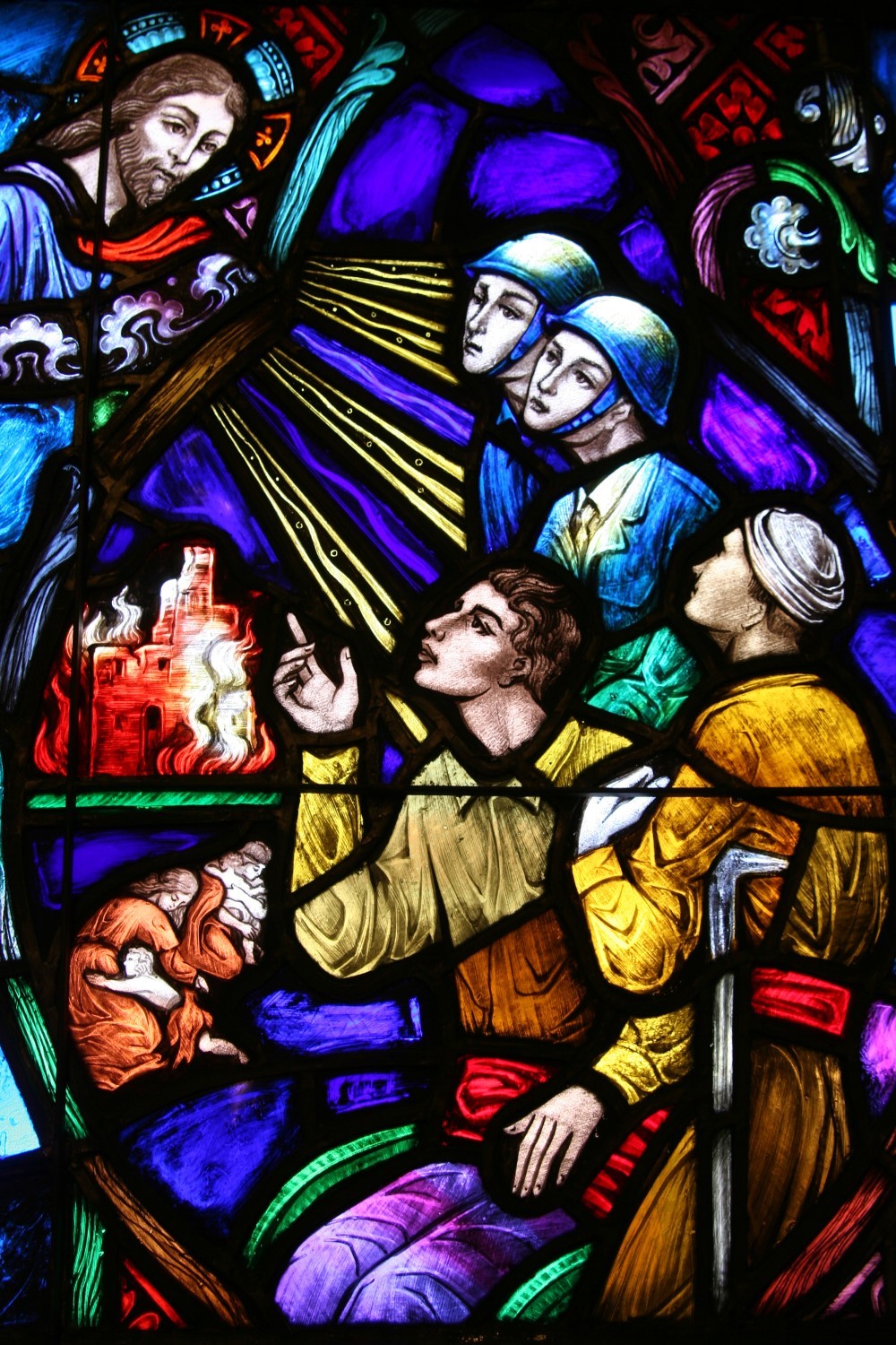 Vivid stained glass detail showing figures and vibrant colors from a restoration project