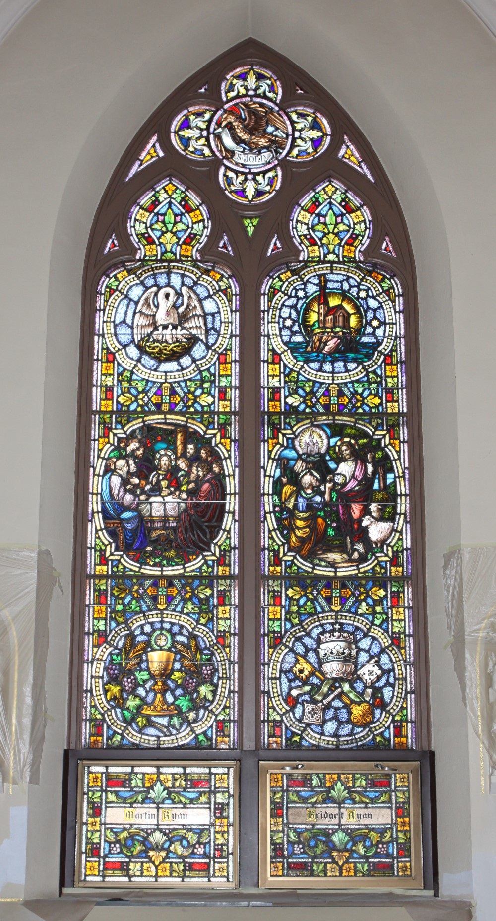 Gothic stained glass window with detailed figural scenes